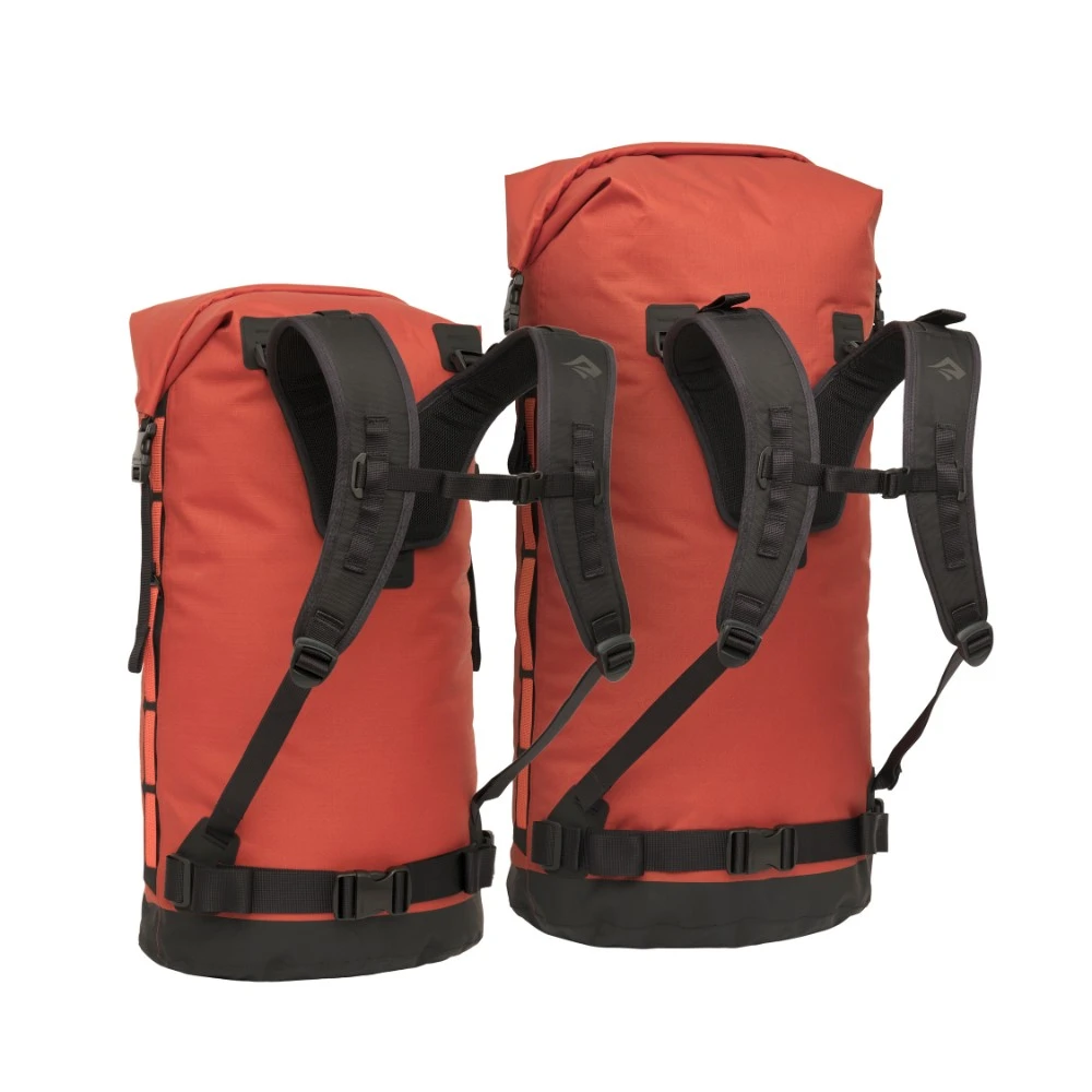 Zwei orangefarbene Big River Dry Backpacks mit einem Fassungsvermögen von 50 Litern, ideal für Motorrad-Camping, mit robusten Schultergurten und schwarzem Unterboden.